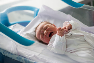 33854438_beautiful-newborn-baby-boy-laying-in-crib-in-prenatal-hospital.jpg
