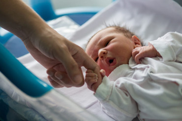 33854462_beautiful-newborn-baby-boy-laying-in-crib-in-prenatal-hospital.jpg